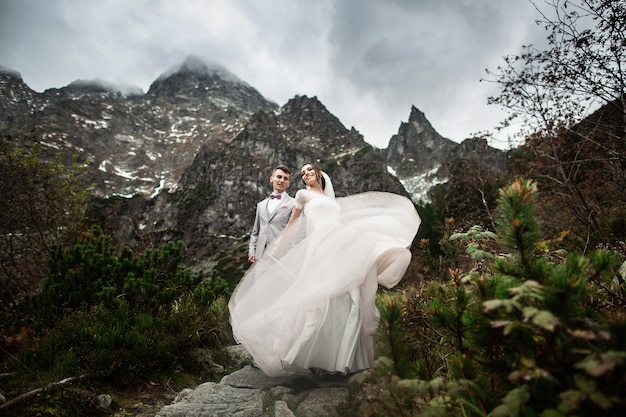 Wedding couple walking near the lake in Tatra mountains in Poland, Morskie Oko 