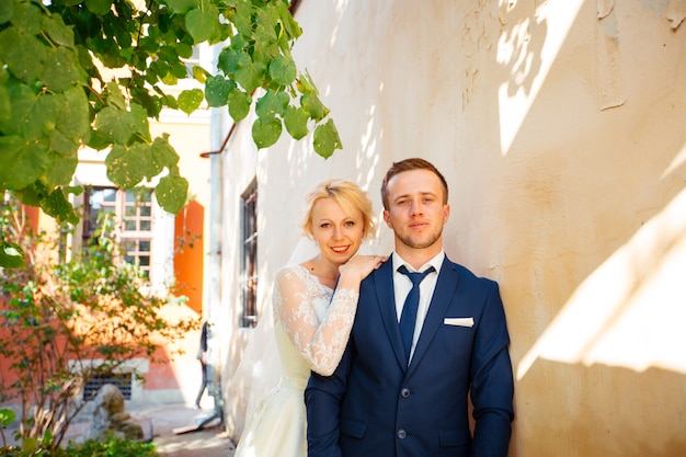 Wedding couple walking on streets of city