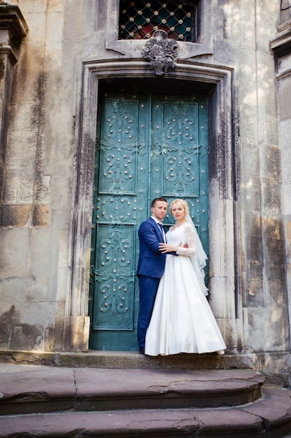 Wedding couple walking on streets of city