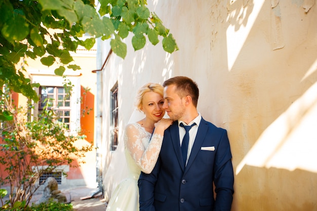 Wedding couple walking on streets of city