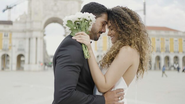 Wedding day beautiful couple in venice action saint mark square embracing young loving man and woman