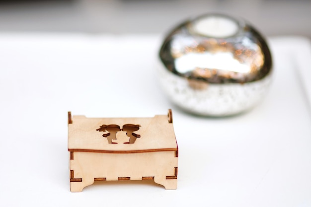 Wedding decor Ring wooden box with inscription on white tableGreen background