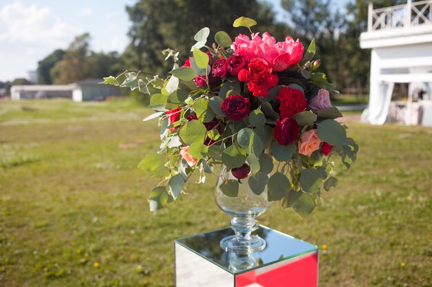 Wedding decor. Wedding registration outdoor. Luxury bouquets with red flowers