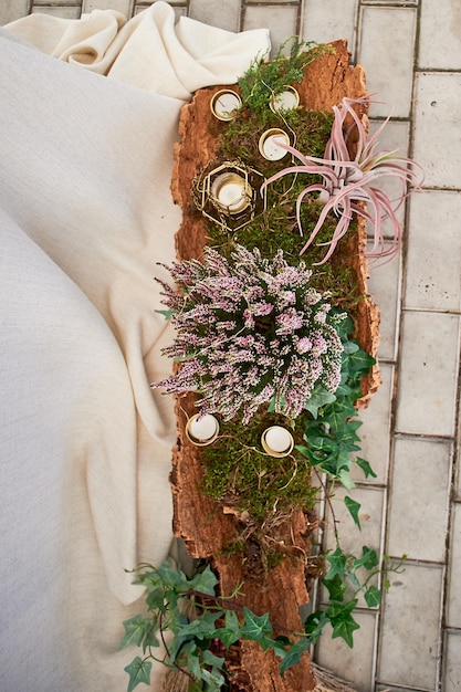 Wedding decoration Old tree bark decorated with moss candles and flowers