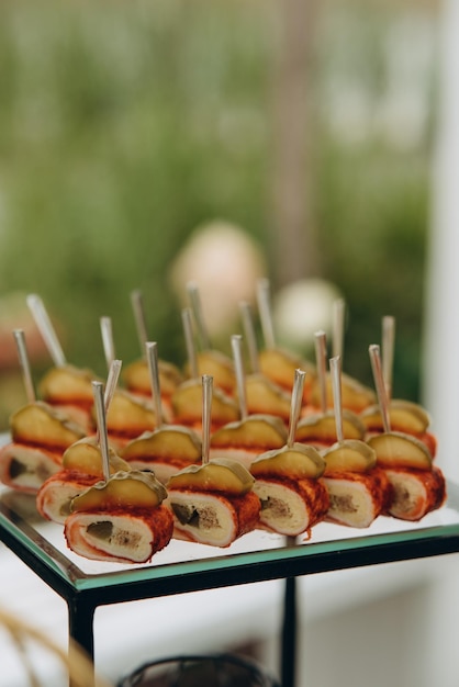 Wedding decorations Reception Buffet Fruits and cheese on plates with bread in boxes Food bar decorated by flowers and lanters