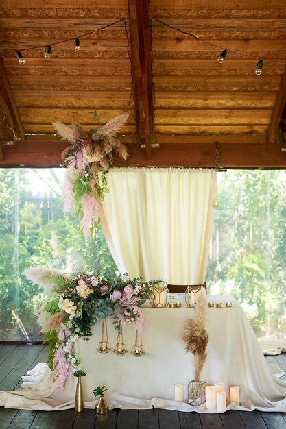 Wedding design with wildflowers and pampas Boho style The bride and groom's tableFloristics