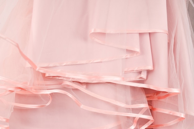 Wedding dress detail. Pink wedding dress frills close up.