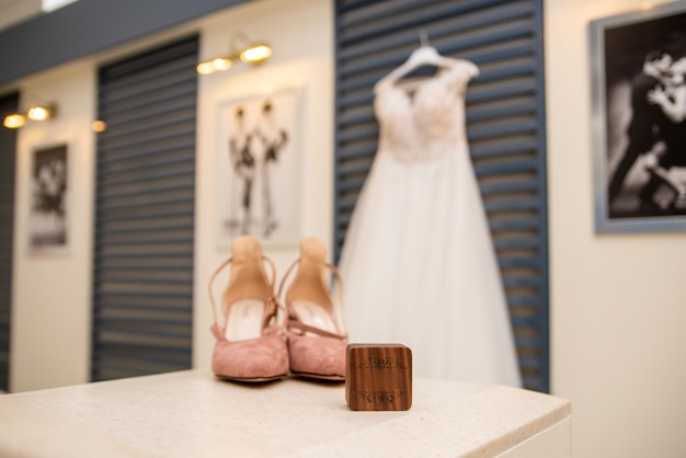 Wedding dress on a hanger bride and shoes