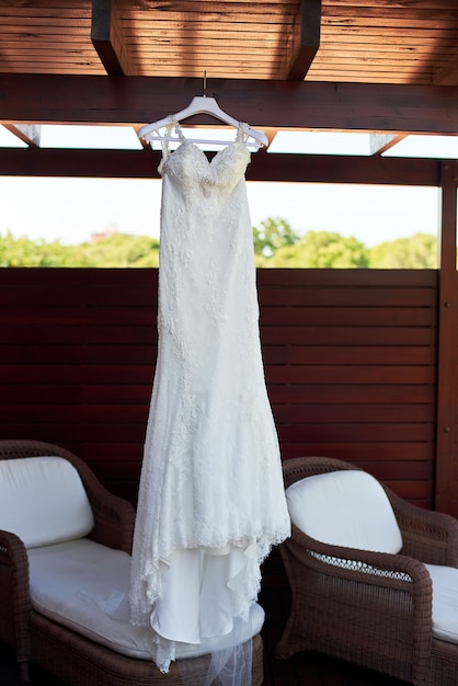 Wedding dress hanging on the ceiling on the balcony