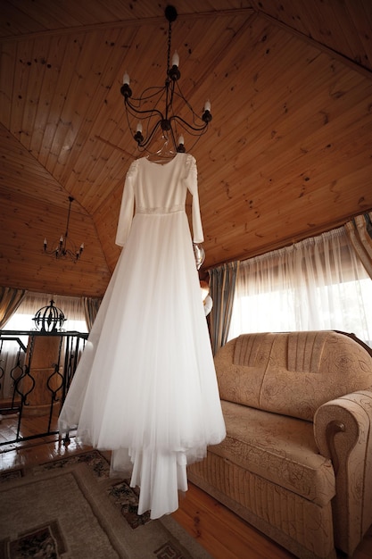 Wedding dress hanging on the chandelier before the wedding 4025