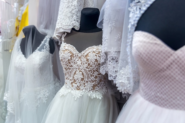 Wedding dresses on mannequins in bridal salon