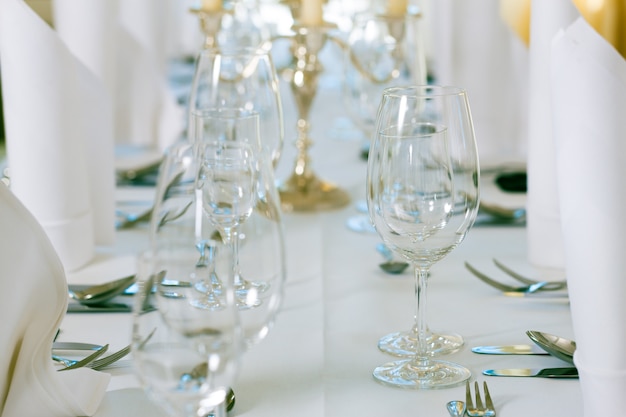 Wedding - feastfully decorated table with silverware and glasses