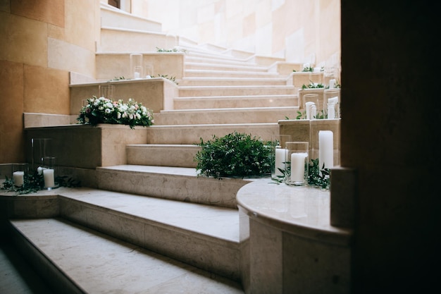 Wedding floral decoration on the stairs with white candlesx9