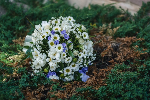 Wedding flower bouquet lies in the grass