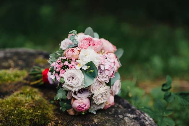 Wedding flower bouquet lies on the stump