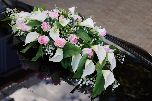 Wedding flowers bouquet closeup tied on the wedding car