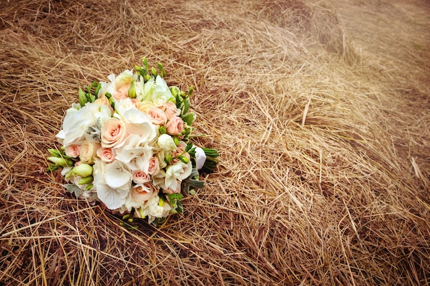 Wedding flowers on the hay field. Rustic style.