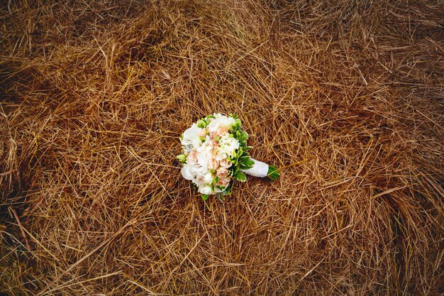 Wedding flowers on the hay field. Rustic style.