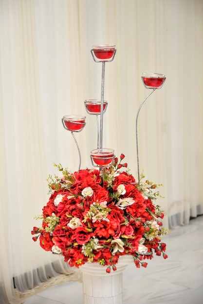 Wedding flowers in vase with glass of red wine