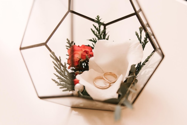 Wedding gold rings of newlyweds in a glass box