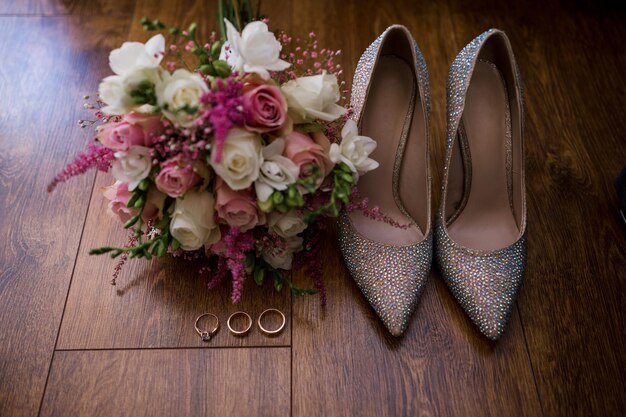 A wedding gold rings with bride shoes and decor