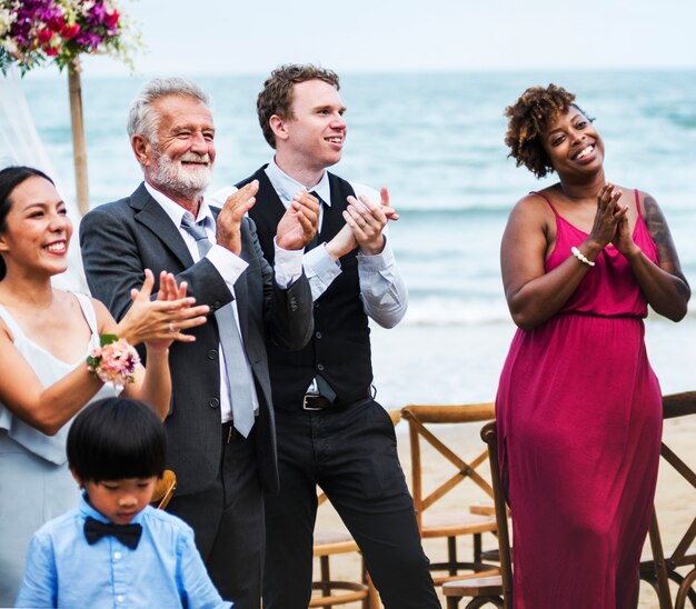 Wedding guests clapping for the bride and groom