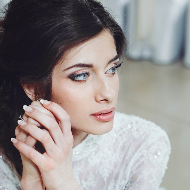 Wedding hair and makeup. Beautiful bride in white dress bride smiling.