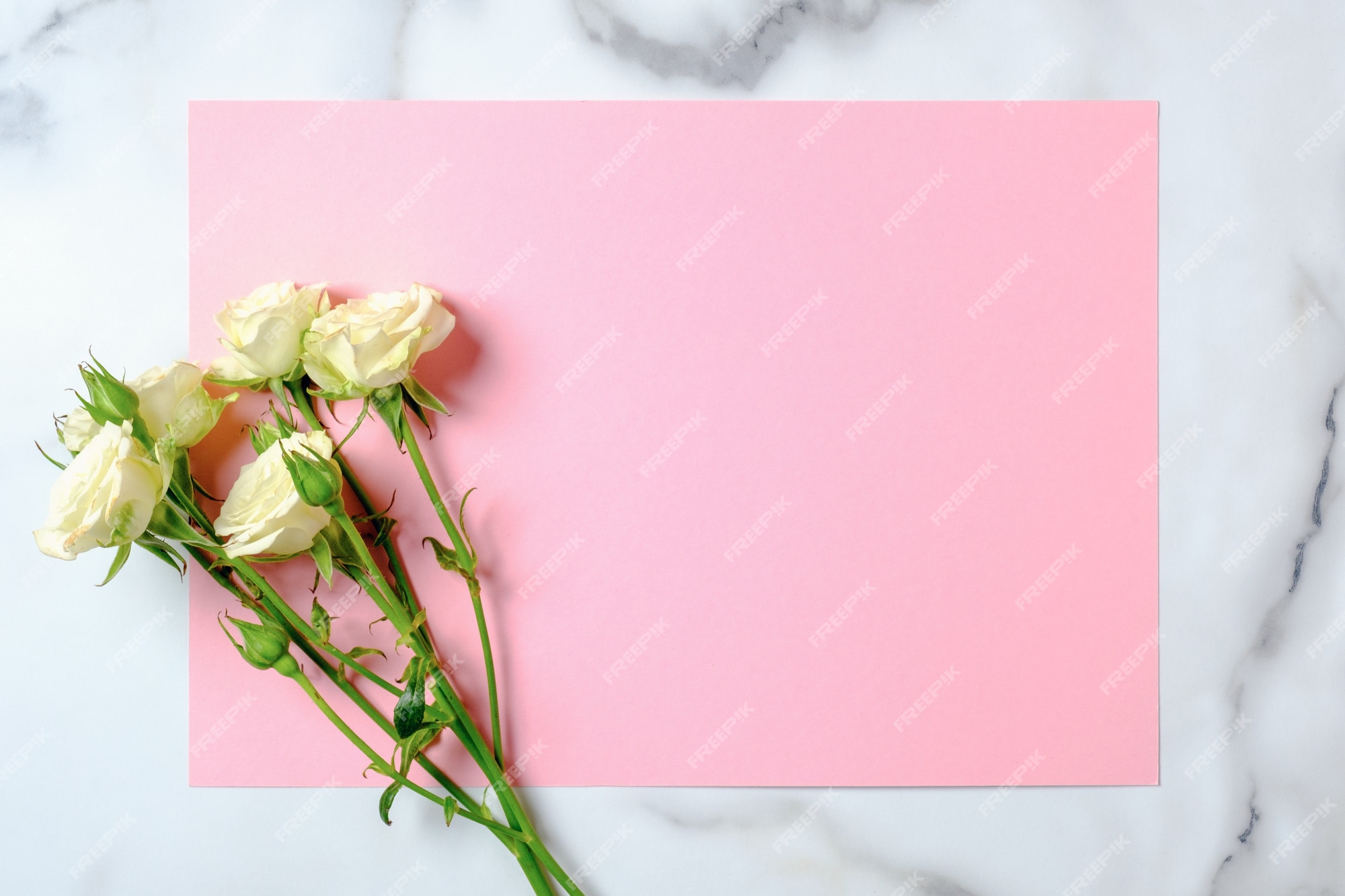 Premium Photo | Wedding invitation card. rose flowers and blank pink paper  card on marble background. wedding concept.