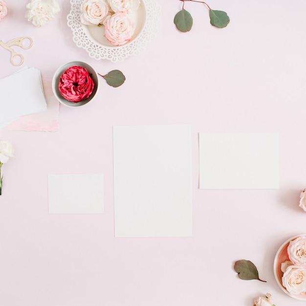 Wedding invitation cards template, pink and red rose flower buds and white carnation on pale pastel pink