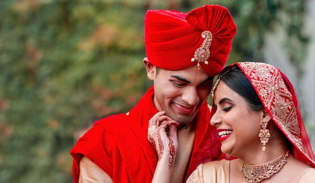 Photo wedding marriage and indian couple together in celebration of love or commitment at a ceremony happy romantic or hindu with a bride and groom getting married outdoor in tradition of their culture