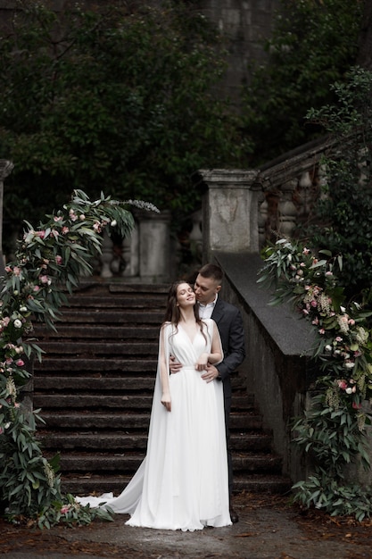 A wedding in an old villa a happy couple of newlyweds Round wedding arch decorated white flowers