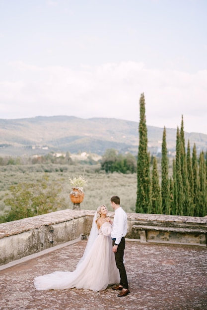 Wedding at an old winery villa in tuscany italy the bride and groom are dancing on the roof of the