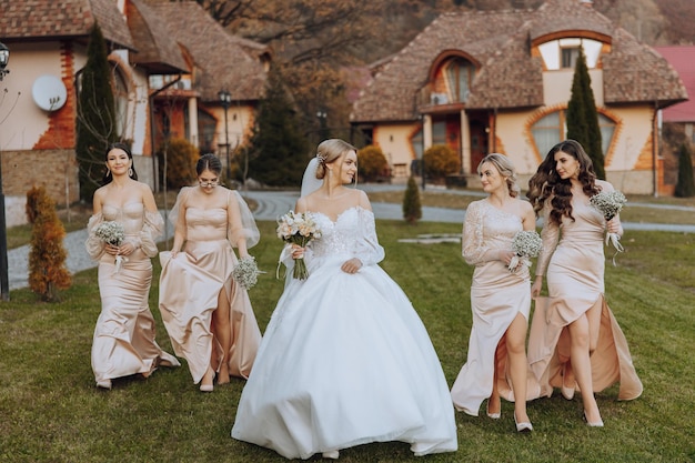 wedding photography a brunette bride in a white dress with a bouquet and her brunette girlfriends