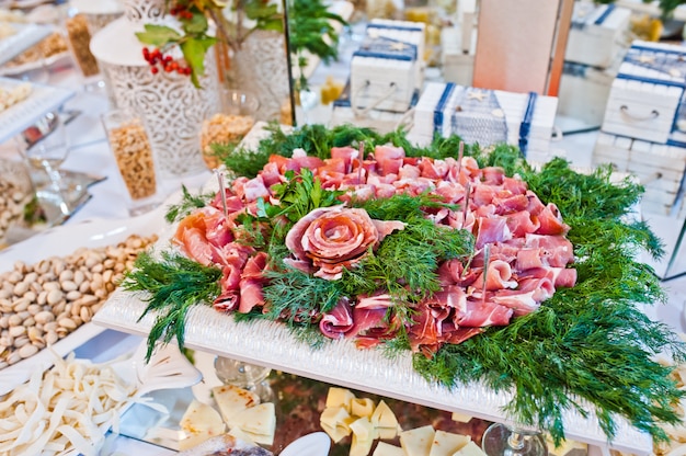 Wedding reception. Table of cheese, meat and peanuts