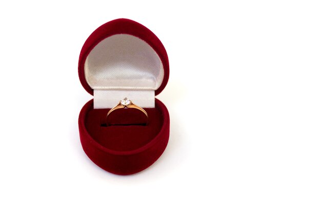 Wedding ring in red case on white isolated background