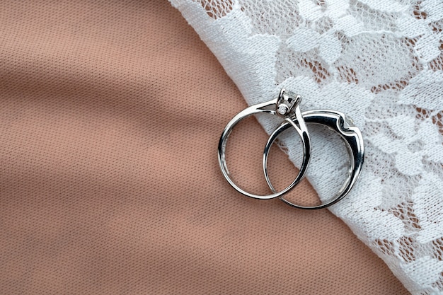 Wedding ring on white fabric with soft-focus