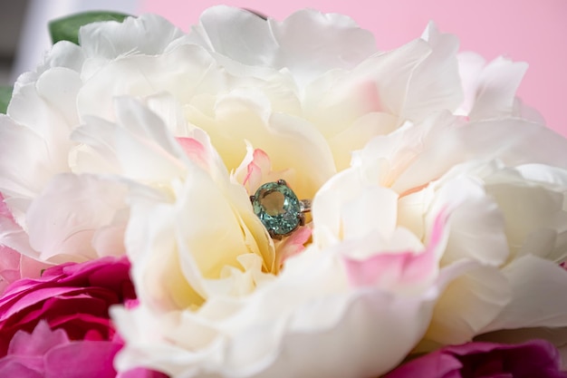 Wedding ring with a large blue topaz in peonies Wedding jewelry composition