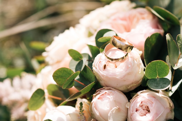 Photo wedding rings in a bouquet of the bride