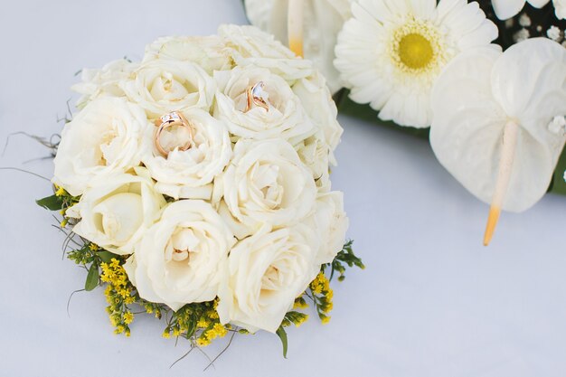 Wedding rings on a bouquet of flowers