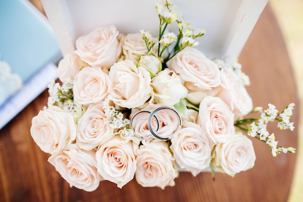 Wedding rings on bouquet macro close up Top view