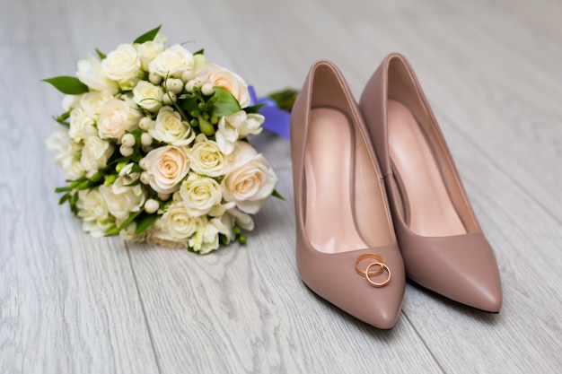 Wedding rings on the bride's shoes.