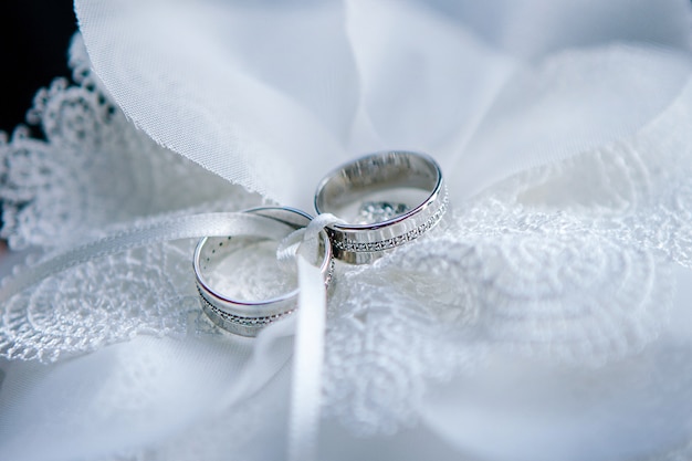 Wedding rings of gold lie on the surface