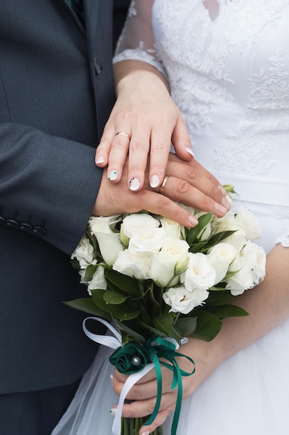 Wedding rings and hands of bride and groom young wedding couple