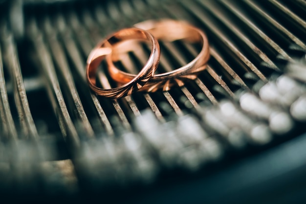 Wedding rings. jewelery in white and yellow gold. Wedding ring on the mirror surface.