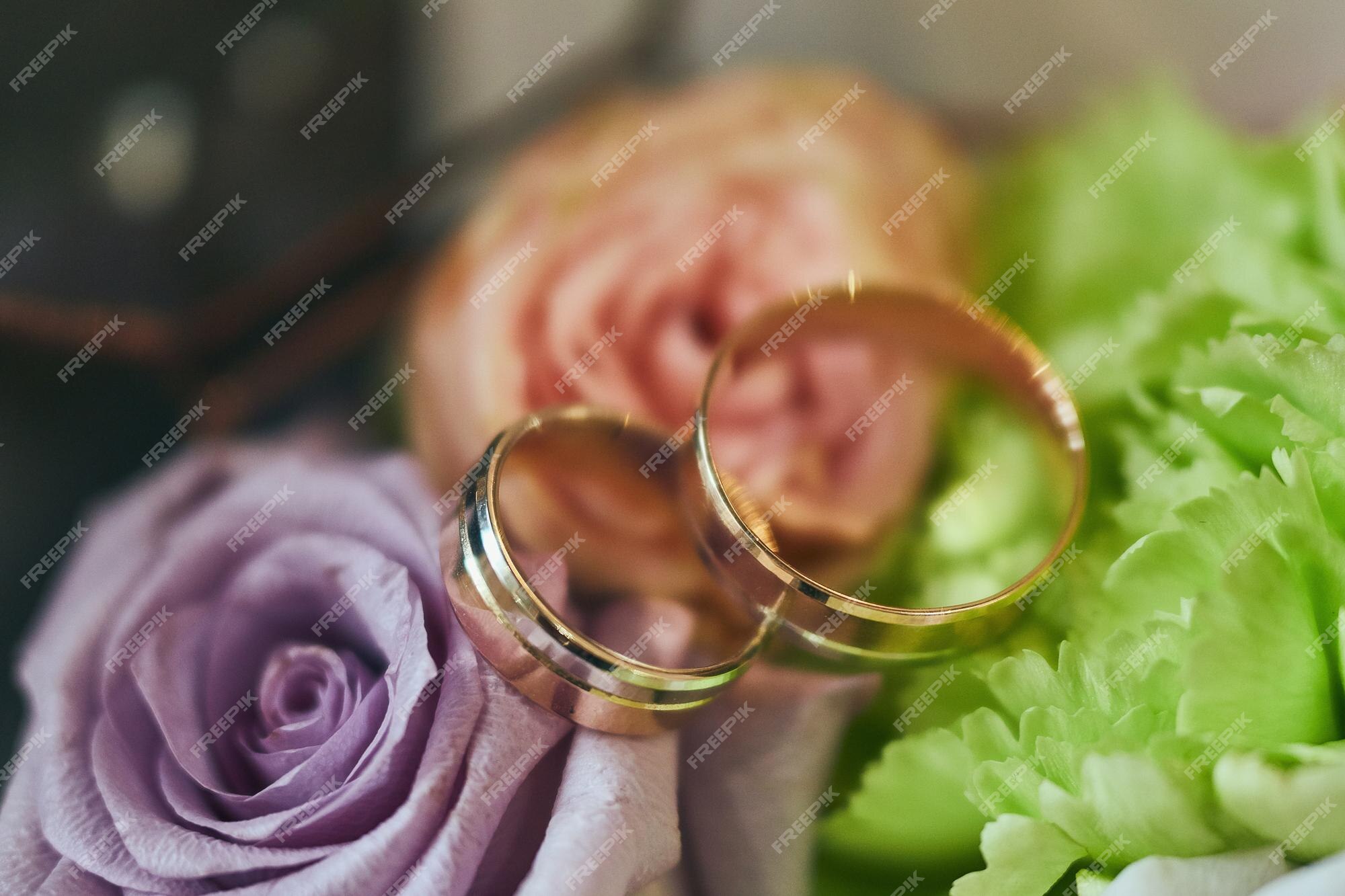 Premium Photo  Wedding rings lie near beautiful bouquet as bridal  accessories