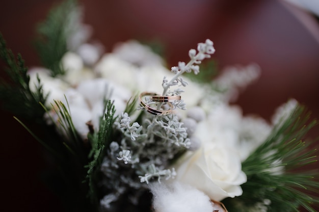 Wedding rings lie on a flower close up