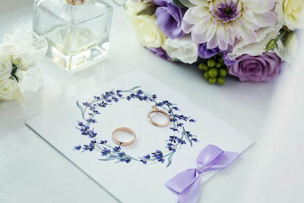 Wedding rings lie near beautiful bouquet as bridal accessories