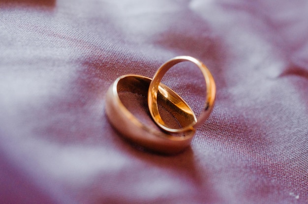 wedding rings lie on a purple cloth