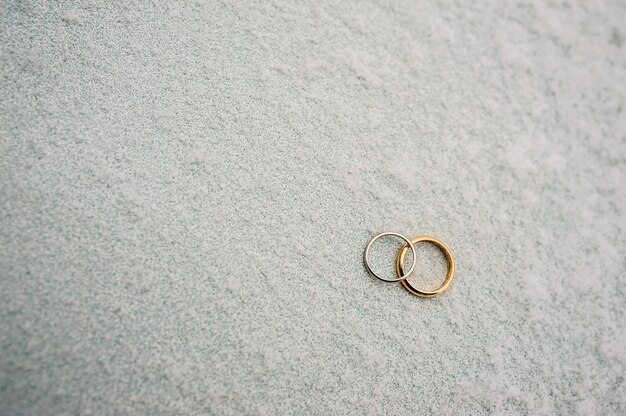 Wedding rings of newlyweds in the snow engagement gold rings