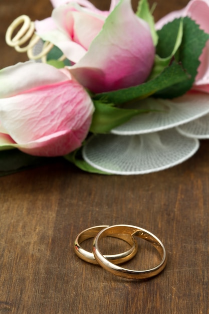 Wedding rings and pink roses